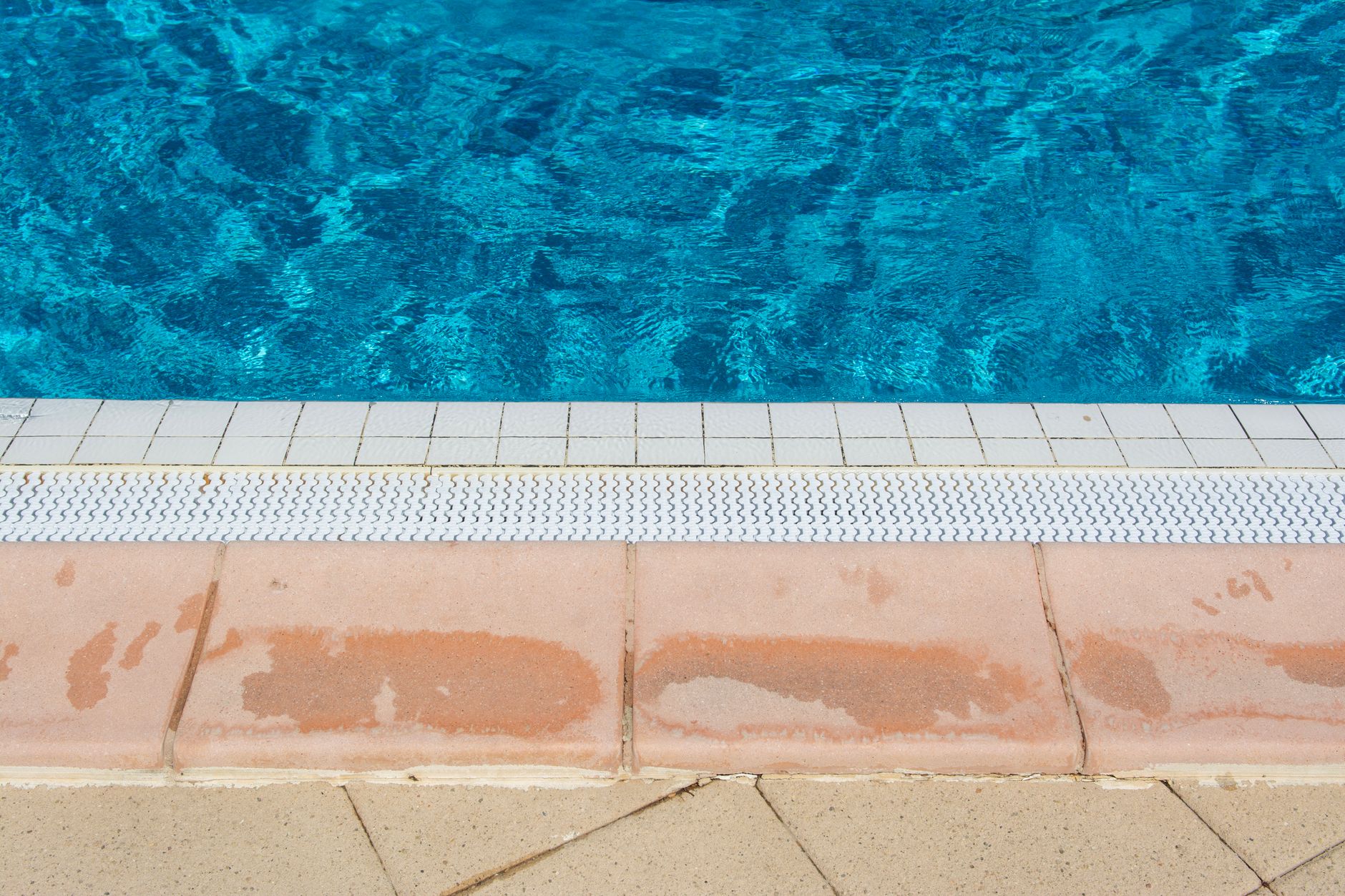 White calcium scale buildup on pool tile waterline in Yuma, Arizona