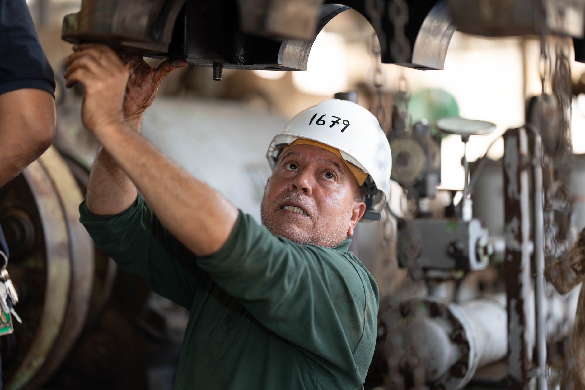 A pool technician inspecting storm-damaged equipment in Yuma, Arizona